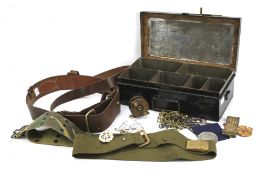 An officer's brown leather belt and a metal box containing an assortment of collectables.