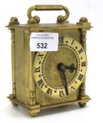 A Smiths brass carriage clock. The dial with Roman numerals, flanked by columns. H11.