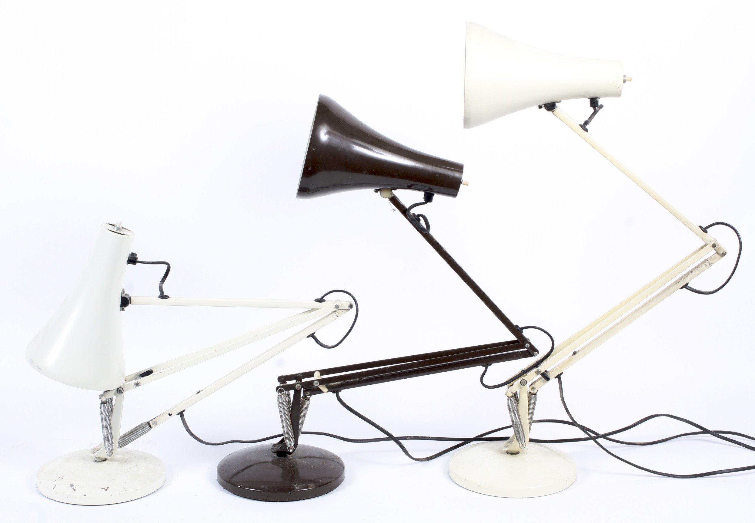 Three anglepoise table lamps in brown cream and white.