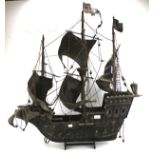 A large wooden model of a Tudor galleon.