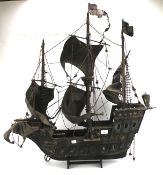 A large wooden model of a Tudor galleon.