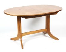 A mid-century G-Plan teak oval extending dining table.