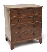 A small mahogany chest of drawers The four drawers with turned handles and raised on bracket