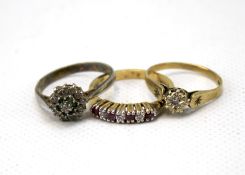 A 9ct gold diamond set ring and two silver rings. The 9ct gold ring weighing 1.