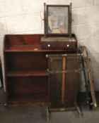 A mahogany bookshelf, swing mirror and three presses.