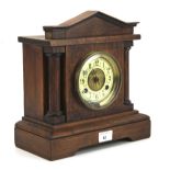 An early 20th century stained wooden mantle clock.