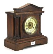 An early 20th century stained wooden mantle clock.