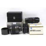 Two Minolta camera lenses and a Sigma lens. The Minolta lenses models AF 100/2.