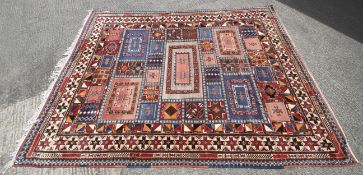 A large rug with orange, blue and red geometric patterns.