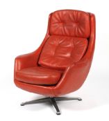 A red upholstered chrome swivel chair, circa 1970.