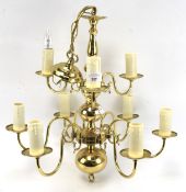 A 20th century brass nine light chandelier in the antique Dutch style with two tiers.