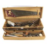 A vintage wooden toolbox containing an assortment of tools.