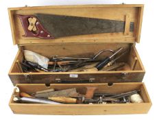 A vintage wooden toolbox containing an assortment of tools.