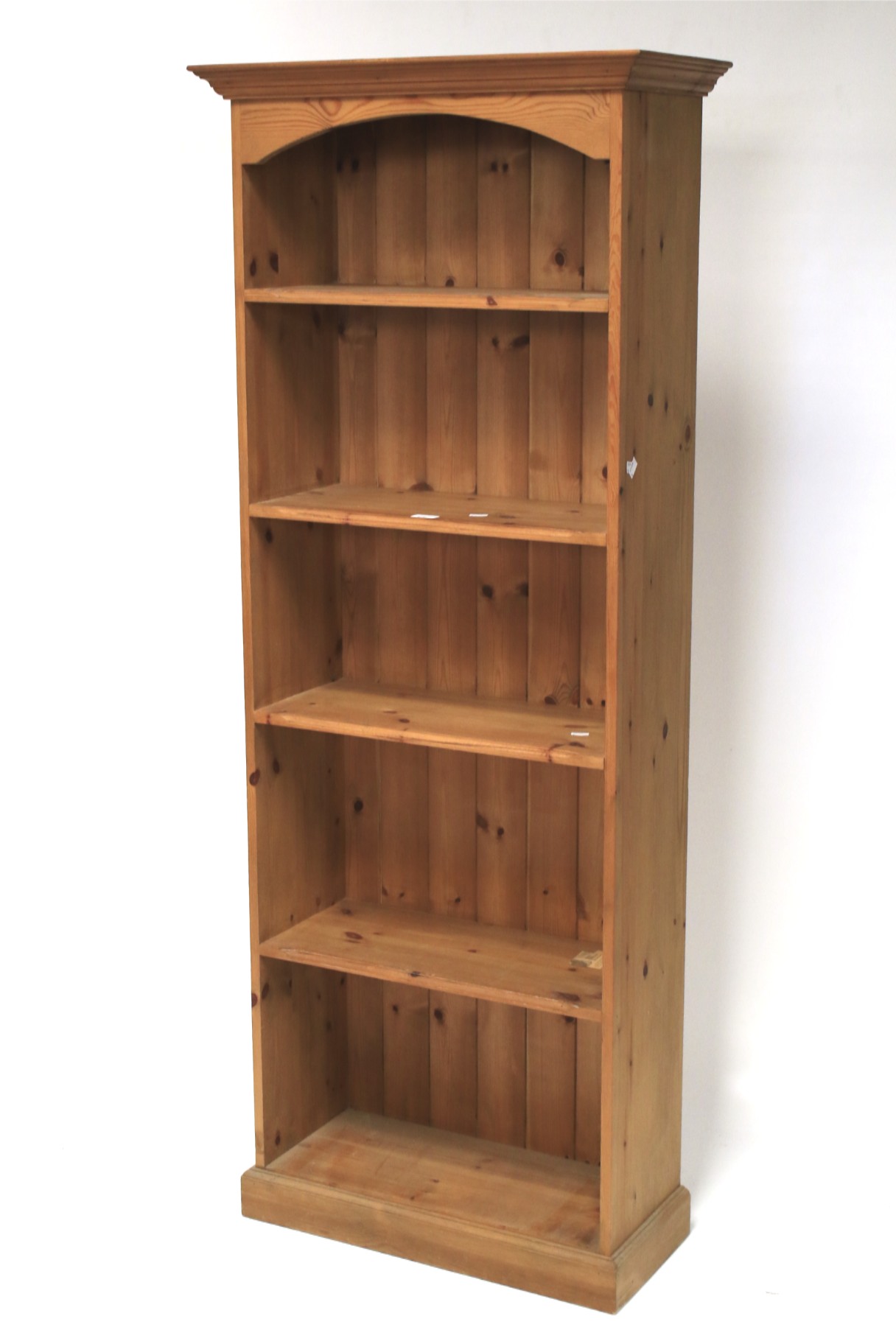 A five shelf pine bookcase.