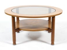 A mid-century glass topped circular coffee table.