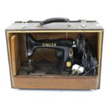 A vintage Singer machine in case. Model 99K, mounted on a wooden case, L47.