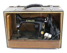 A vintage Singer machine in case. Model 99K, mounted on a wooden case, L47.