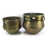 Two cast metal cauldron pots.