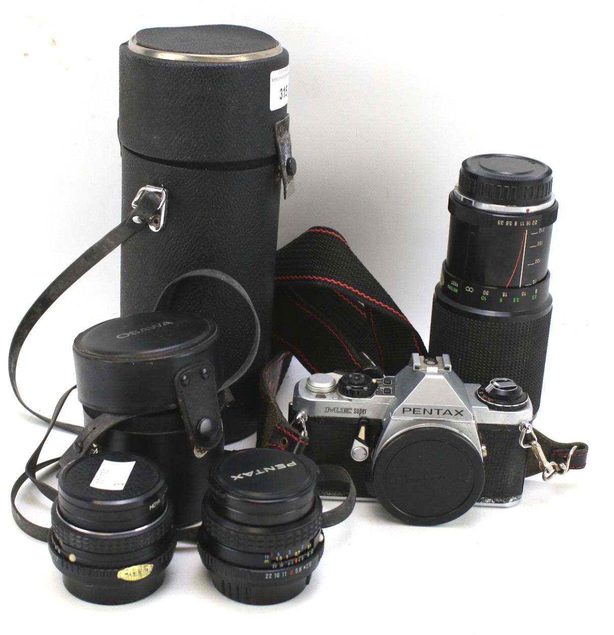 A Pentax 35mm SLR camera and three lenses.
