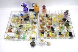 An assortment of contemporary miniature perfume bottles and fans.