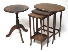 A nest of three tables and a rosewood tripod table.