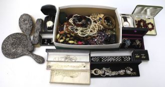An assortment of costume jewellery and a silver dressing table set.