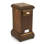 A 20th century wooden cased money box. With a sliding drawer to the top, raised on bun feet, H27.