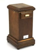 A 20th century wooden cased money box. With a sliding drawer to the top, raised on bun feet, H27.