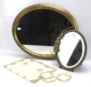 An oval gilt framed wall mirror and a barbola mantel mirror.