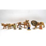 Four Beswick lions and four Royal Doulton Bunnykins figures.