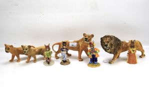 Four Beswick lions and four Royal Doulton Bunnykins figures.
