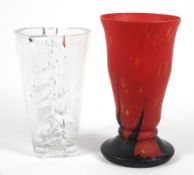 A 20th century red and black opaque glass vase and a Nachtmann moulded clear glass vase.