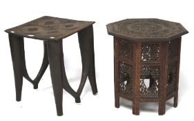 A folding carved Indian side table together with a tribal table.