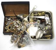An assortment of costume jewellery and flatware.