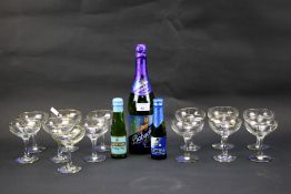 Thirteen Babycham glasses and three bottles of Babycham.