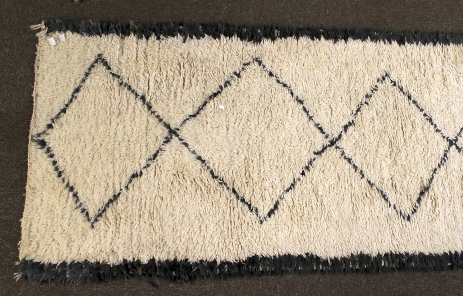 A large woollen floor runner rug. - Image 2 of 2