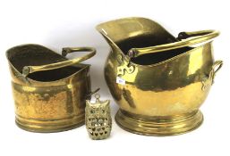 Two brass coal scuttles and a candle holder modelled as an owl.