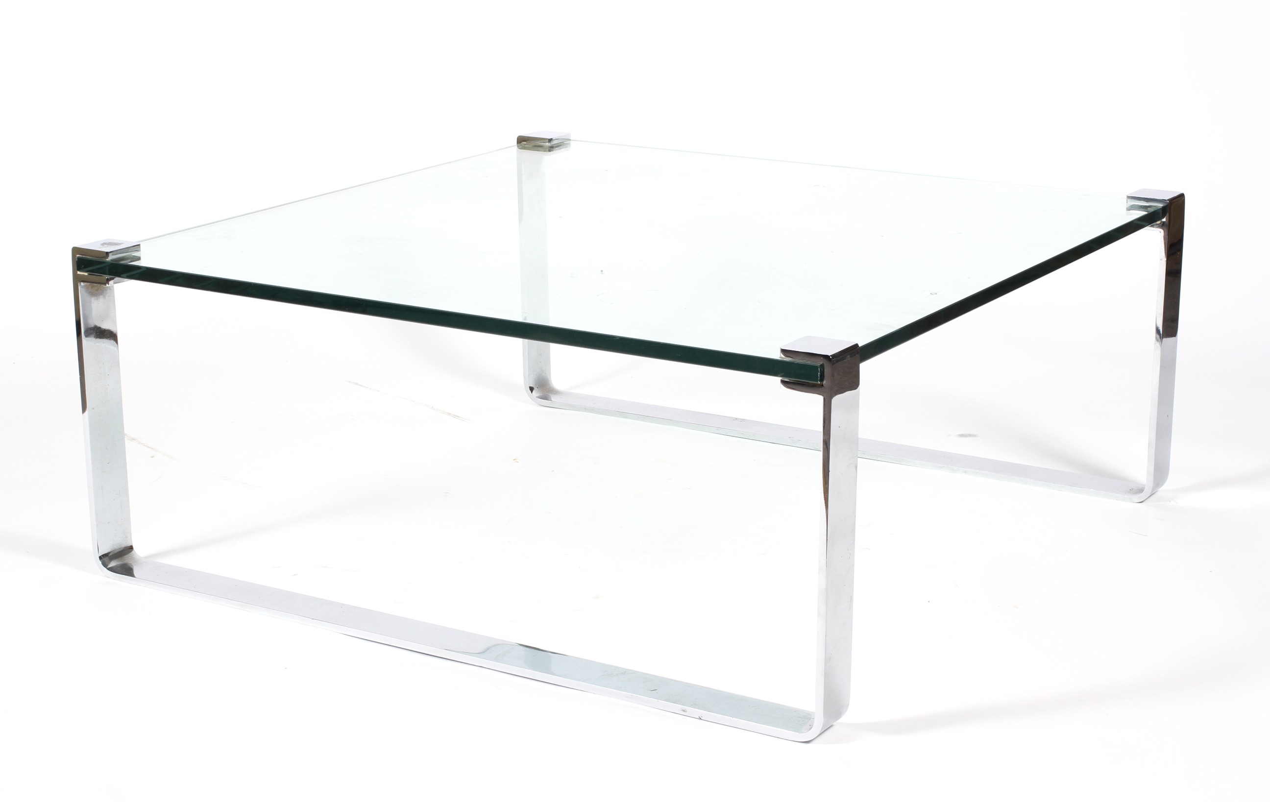 A large chrome and heavy glass coffee table designed by Friedrich Wilhelm Moller for Ronald Schmitt