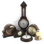 Five 20th century clocks and a barometer.