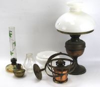 A vintage brass railway/ship's oil lamp on mount and other lamps.