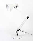 A white anglepoise table lamp.