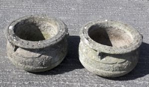 A pair of large reconstituted stone garden planters.