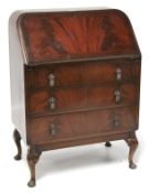 A mid-century flamed mahogany veneered bureau.