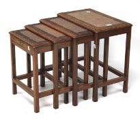 A nest of four 20th century hard wood tables.