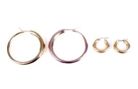 Two pairs of modern Italian gold hollow-hoop earrings.