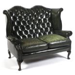 A Georgian style button back green leather sofa, 20th century.