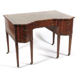 A late 19th/early 20th century leather topped mahogany serpentine desk.