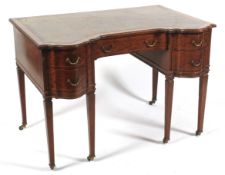 A late 19th/early 20th century leather topped mahogany serpentine desk.