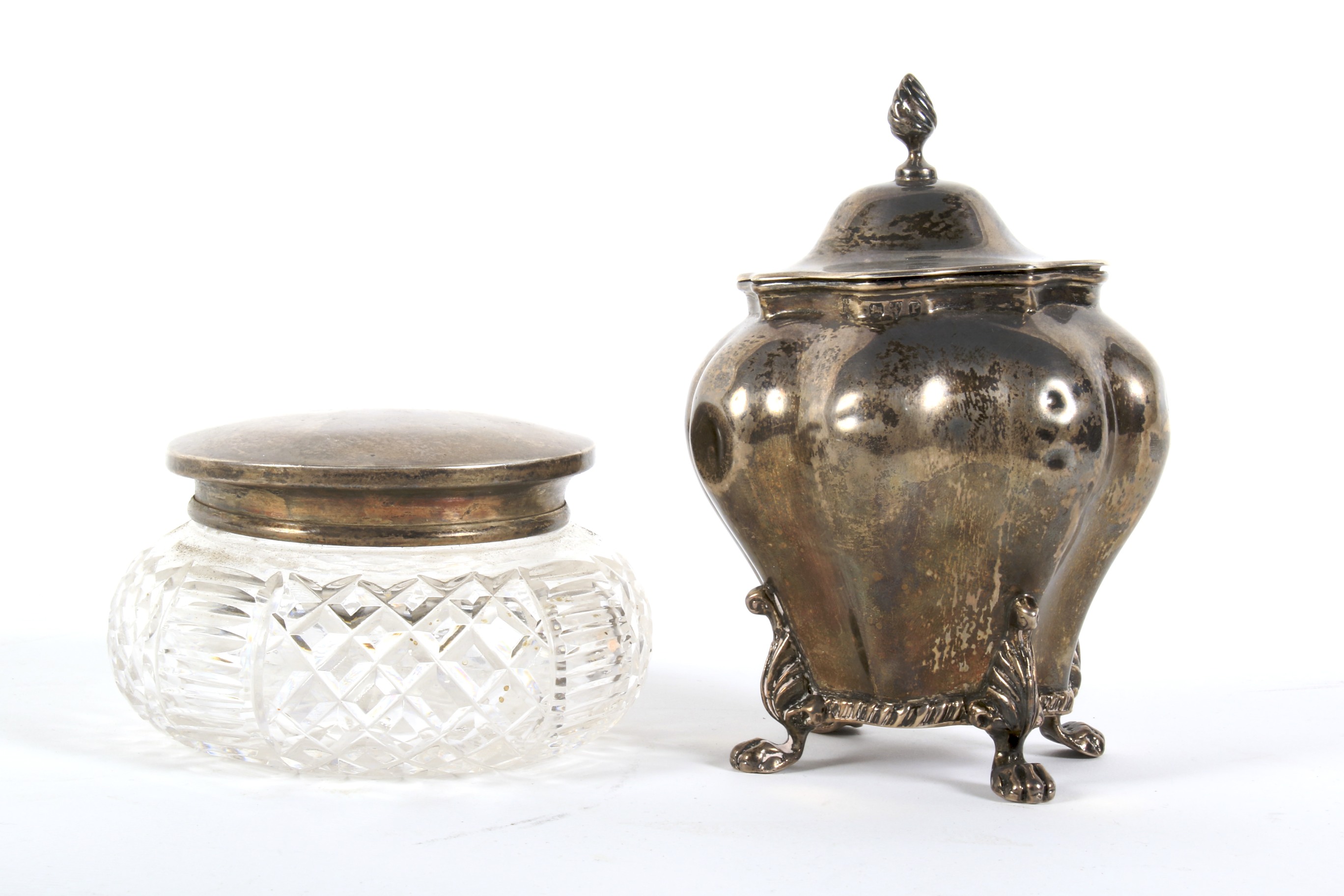 A late Victorian silver tea caddy and a silver mounted glass jar.