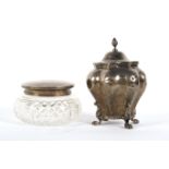 A late Victorian silver tea caddy and a silver mounted glass jar.